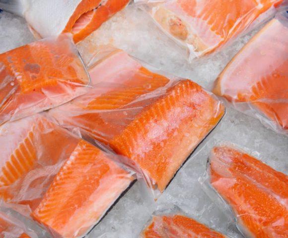 Fresh salmon fillet in plastic packing for sell in supermarket or seafood market. Healthy food.